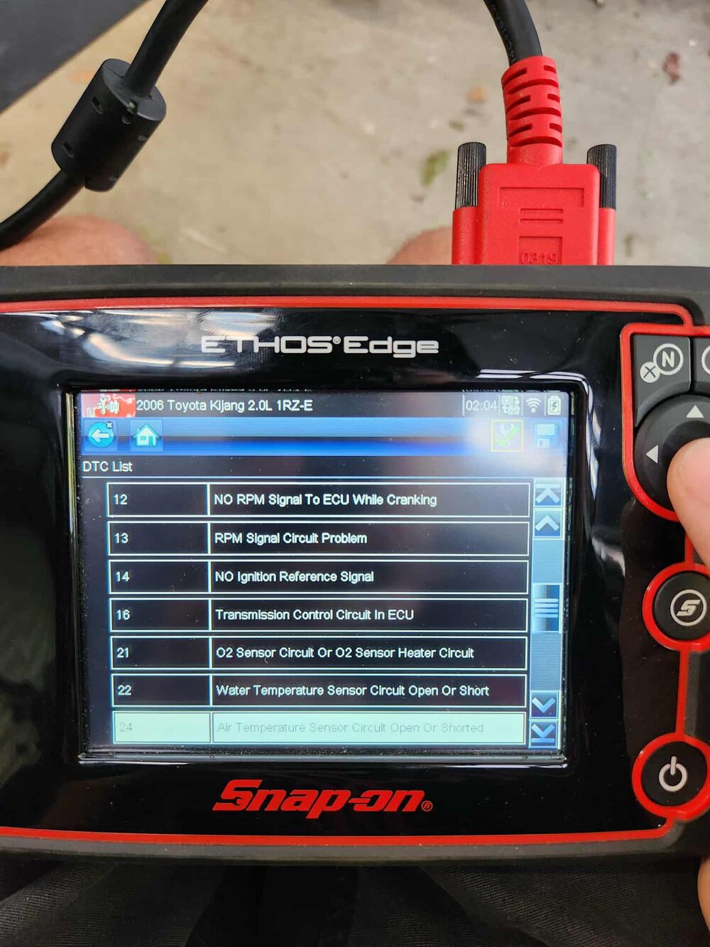 Snap-on diagnostic scanner reading fault codes from a vehicle.
